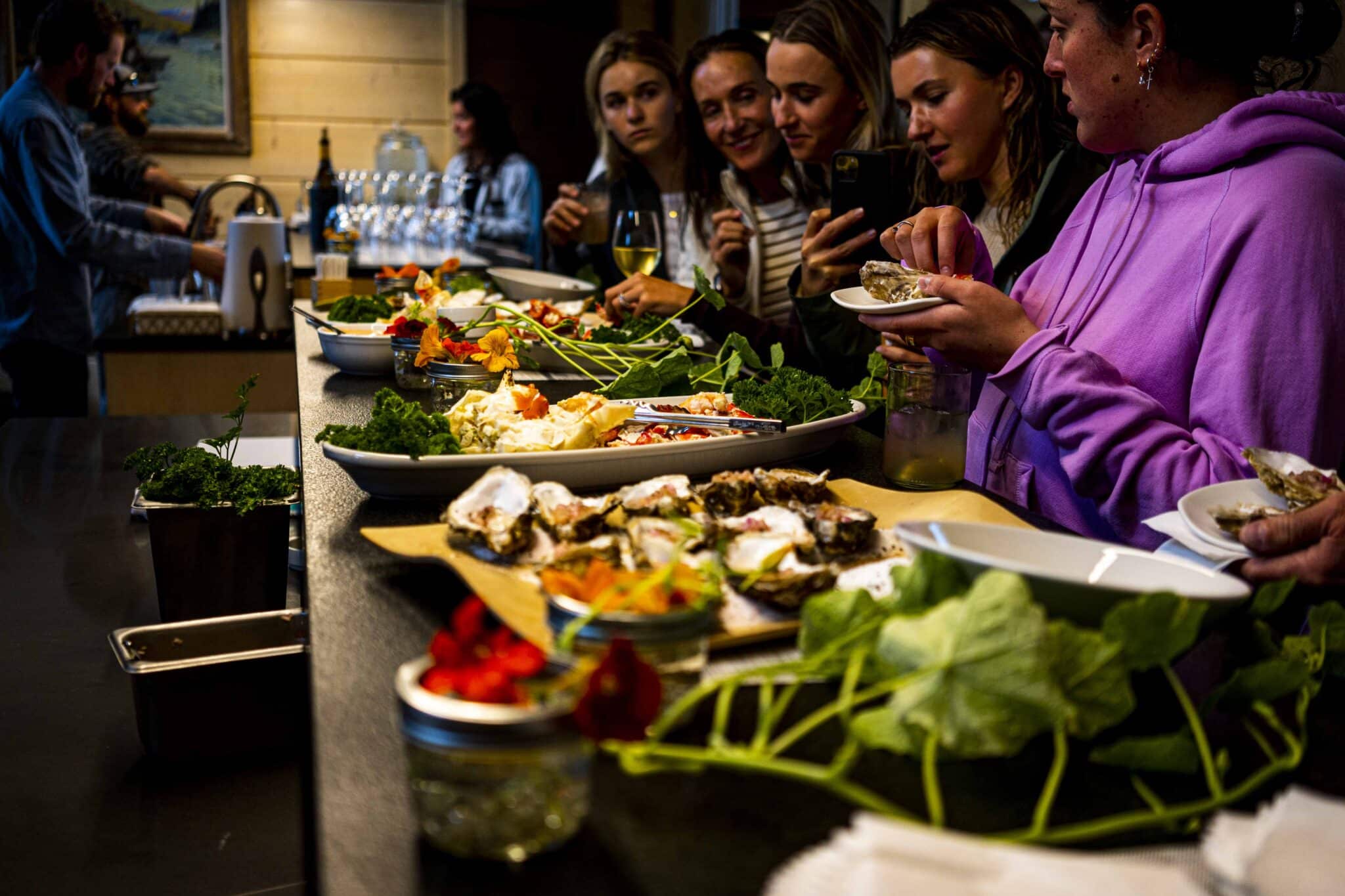 a dinner spread of king crab, oysters, and sushi